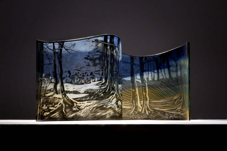 Glass Workshop in Elora showcasing a beautifully painted glass piece with trees and landscape imagery.