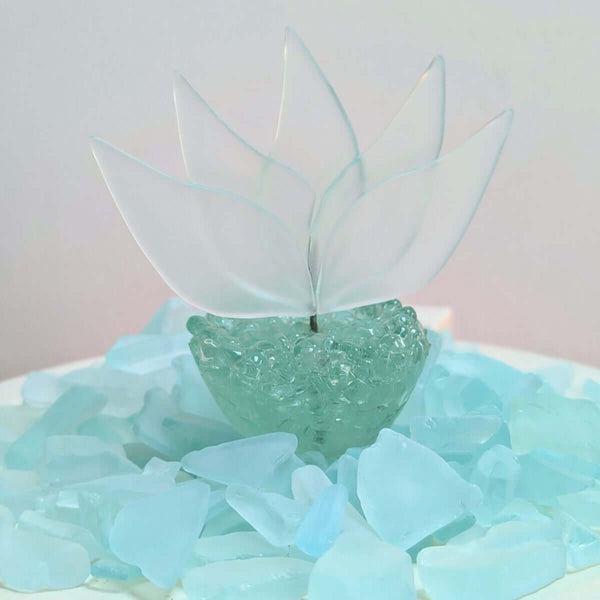 glass lotus flower on a bed of crushed glass